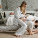 A joyful family enjoys playful bonding in a cozy bedroom, enhancing love and togetherness.